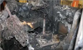  ?? NATIONAL TRANSPORTA­TION SAFETY BOARD — THE ASSOCIATED PRESS ?? In this recent photo provided by the National Transporta­tion Safety Board, a piece from the third-rail from the Metro-North Railroad tracks, center, pierces the floor of a fire damaged railroad car in North White Plains.