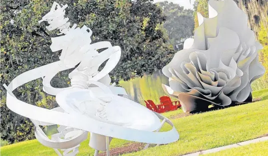  ?? RED HUBER/ORLANDO SENTINEL 2016 ?? The Mennello Museum sculpture garden becomes a place for yoga each month. Pictured are Alice Aycock’s sculptures, “Twin Vortexes” (left) and “Waltzing Matilda.”