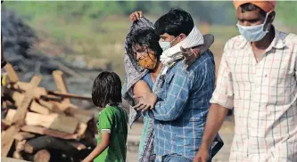  ??  ?? RELATIVES mourn during the cremation of their loved one, who died from Covid-19, at a cremation ground in Allahabad this week.