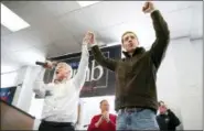  ?? ANTONELLA CRESCIMBEN­I — PITTSBURGH POST-GAZETTE VIA AP ?? Cecil Roberts, president of the United Mine Workers, left, lifts up Democratic candidate Conor Lamb’s hand as the crowd erupts in cheers and chants during a rally, Sunday at the Greene County Fairground­s in Waynesburg, Pa.