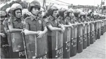  ??  ?? S.O.N.A. SECURITY – Members of the Philippine National Police stand like a wall to secure the vicinity of the Batasang Pambansa in Quezon City for President Duterte’s State of the Nation Address yesterday. More than 6,000 police personnel were deployed...