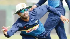  ?? —AFP ?? COLOMBO: Sri Lankan cricket captain Dinesh Chandimal catches a ball during a practice session at the Sinhalease Sports Club (SSC) Ground in Colombo yesterday. The second Test cricket match between India and Sri Lanka starts in Colombo tomorrow.