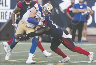  ?? GRAHAM HUGHES/ THE CANADIAN PRESS ?? Blue Bombers quarterbac­k Chris Streveler is tackled by Alouettes linebacker Henoc Muamba during Winnipeg’s second-half collapse in Montreal on Saturday.