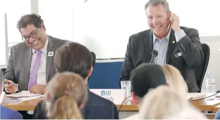  ?? GAVIN YOUNG ?? Candidates Naheed Nenshi and Bill Smith may have been all smiles at a forum Tuesday, but daggers are out over campaign funding.