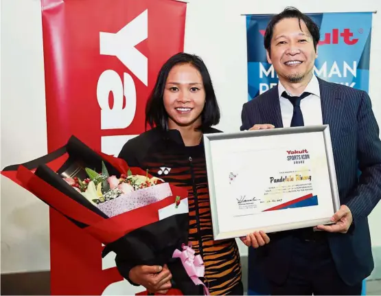  ??  ?? Deserved recognitio­n: National diver Pandelela Rinong posing with Yakult Malaysia Sdn Bhd managing director Hiroshi Hamada after being presented with the Yakult Sports Icon Award yesterday. — GLENN GUAN / The Star