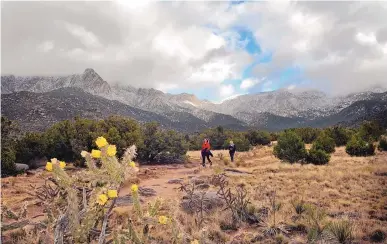  ?? JIM THOMPSON/JOURNAL ?? Hikers walk along Pino Trail in the Elena Gallegos Open Space in November 2016.