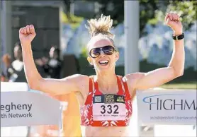  ?? Bob Donaldson/Post-Gazette ?? Jennifer Bigham of Squirrel Hill sprints to the finish line to win the women's 10K in the Great Race Sunday.