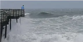  ?? AP ?? Waves lash the Avalon Fishing Pier in Kill Devil Hills, North Carolina, on Thursday as Hurricane Florence approaches