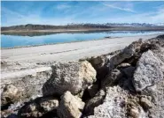  ?? STEVE MARCUS/LAS VEGAS SUN VIA AP ?? Waste salt, foreground, is shown near an evaporatio­n pond at the Silver Peak lithium mine near Tonopah, Nev., in January 2017.