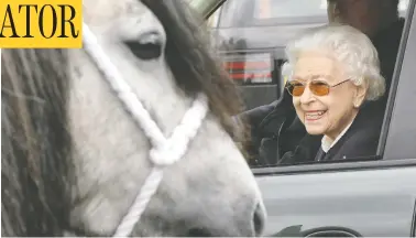  ?? CHRIS JACKSON/GETTY IMAGE ?? Queen Elizabeth, in sunglasses and bright pink lipstick, watches the horses from her Range Rover at
the Royal Windsor Horse Show in Windsor, England, on Friday. The event is said to be her favourite.