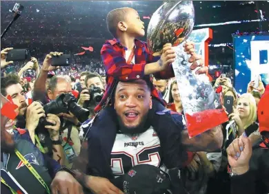  ?? AL BELLO/AFP ?? Justin Coleman of the New England Patriots celebrates with the Vince Lombardi Trophy after the Patriots defeated the Atlanta Falcons 34-28 in the Super Bowl on Sunday in Houston, Texas. Many in China watched the game on their way to work.