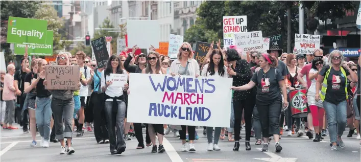  ?? Picture / Doug Sherring ?? The Women’s March against President Donald Trump spread to streets around the world, including Queen St in Auckland, in January.