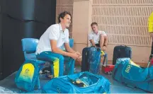  ??  ?? Cameron McEvoy organises his Commonweal­th Games kit bag after collecting his uniform.