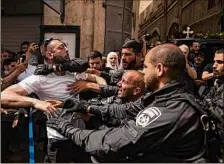  ?? Amir Levy / Getty Images ?? Police clash with attendees of the funeral of Al Jazeera reporter Shireen Abu Akleh, who witnesses say was shot while covering an Israeli military raid in the West Bank.