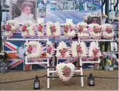  ?? ALBERTO PEZZALI/AP ?? A floral tribute honoring Princess Diana stands Wednesday outside Kensington Palace in London.