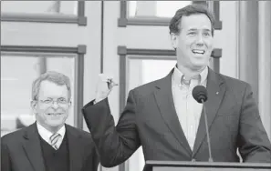  ?? By Jay Laprete, Getty Images ?? Support from a former colleague: Rick Santorum speaks in Columbus with Ohio Attorney General Mike Dewine, left, on Friday after Dewine, a former senator, endorses Santorum’s presidenti­al bid.