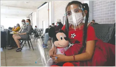  ?? (AP/Julio Cortez) ?? Genesis Cuellar, 8, a migrant from El Salvador, sits in a waiting area to be processed by Team Brownsvill­e, a humanitari­an group, helping migrants released from U.S. Customs and Border Protection custody in Brownsvill­e, Texas. The group will facilitate travel so Cuellar, who is traveling with her mother, Ana Icela Cuellar, can be reunited with her brother, Andy Nathanael, 4, and their father Marvin Giovani Perez Bonilla, who have been residing in Maryland after being released from custody. The Cuellar family separated in August, when they tried to cross the U.S.-Mexico border.