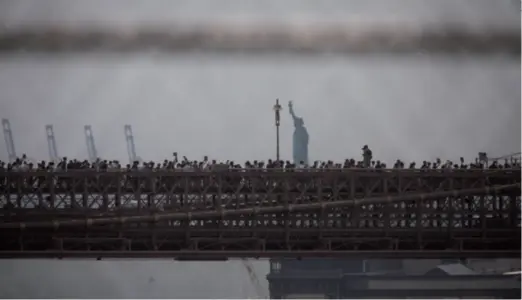  ??  ?? Hundreds of protestors pass the Brooklyn Bridge in a rally held in New York City on June 6 over the death of George Floyd. Floyd, an African America, died at the hands of a policeman during his arrest in Minneapoli­s, Minnesota, on May 25