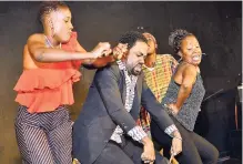  ??  ?? Kishawna Gordon (left) and Norlene Pryce-Brown, drama teachers at Bridgeport High school, dancing Dinki Mini with Akeem Mignott (centre), a past student and host of Bridgeport High School’s Evening of Excellence.