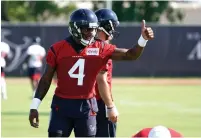  ?? AP Photo/ David J. Phillip ?? ■ Houston Texans quarterbac­k Deshaun Watson (4) signals a receiver during training camp Thursday in Houston.