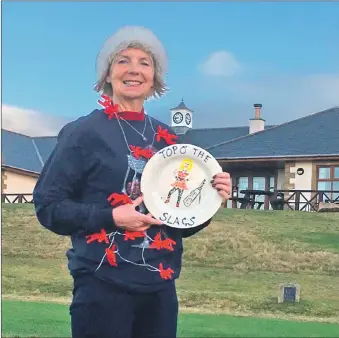  ??  ?? Alice Anderson with The Shiskine Ladies Away Golfing Society Tour trophy.