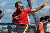  ?? AFP ?? Ferrari’s German driver Sebastian Vettel waves during the drivers’ parade ahead of the start of the Japanese GP on Sunday. —