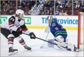  ?? The Canadian Press ?? Vancouver Canucks goaltender Jacob Markstrom stops Arizona Coyotes forward Mario Kempe during the first period of Thursday’s game in Vancouver.