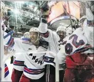  ?? — GETTY IMAGES ?? Rangers players celebrate after Marian Gaborik scored the game-winner in triple overtime early Thursday.