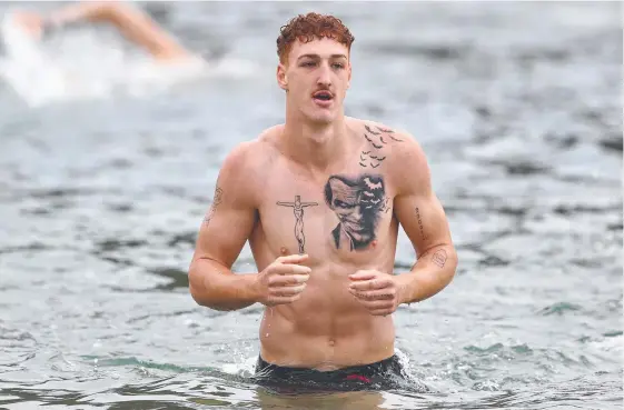  ?? Picture: CHRIS HYDE/GETTY IMAGES ?? Young Suns player Matthew Conroy shows off his tattoos at a training session at Palm Beach Parklands.