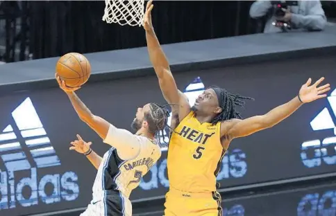  ?? WILFREDO LEE/AP ?? Magic guard Michael Carter-Williams goes up for a shot against Heat forward Precious Achiuwa during the first half Thursday night in Miami.