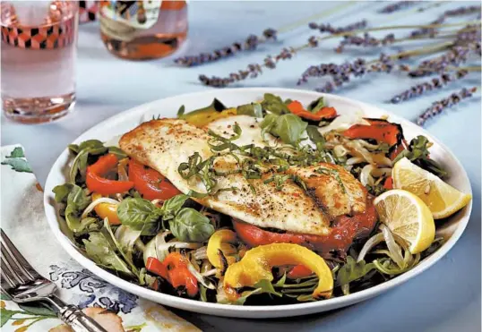  ?? ABEL URIBE/CHICAGO TRIBUNE PHOTOS; SHANNON KINSELLA/FOOD STYLING ?? The Provencal-style fish salad, made here with broiled tilapia, is inspired by the bounty of tomatoes, onion, garlic and bell peppers at the farmers market.