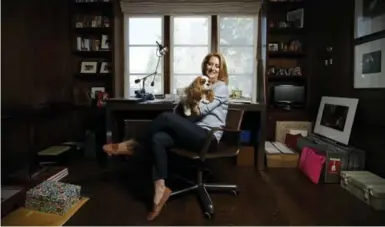  ?? COLE BURSTON FOR TORONTO STAR ?? Eleanor McCain, with cavalier King Charles spaniel Audrey, in her uptown Toronto home office.