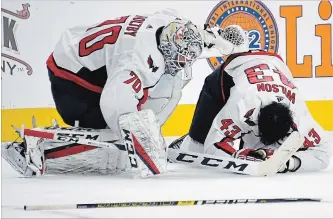  ?? ETHAN MILLER GETTY IMAGES ?? Washington Capitals goaltender Braden Holtby checks on teammate Tom Wilson after he was hurt following a blindside hit by Ryan Reaves of the Golden Knights on Tuesday in Las Vegas.