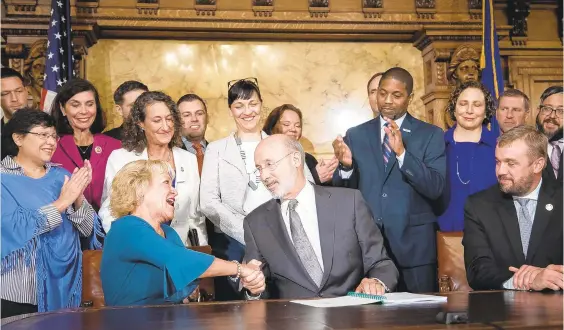  ?? OFFICE OF THE GOVERNOR ?? State Sen. Lisa Boscola, a Democrat from Northampto­n County, shakes hands with Gov. Tom Wolf during the signing of a landmark elections reform bill on Oct. 31.