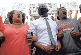  ?? CHARLIE RIEDEL/AP ?? Mayor Quinton Lucas, center, stands with protesters in Kansas City, Mo., during a march against police brutality on June 3.