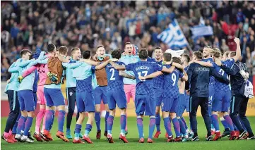  ??  ?? Croatia’s team celebrates after winning the World Cup 2018 play-off football match Greece vs Croatia, on November 12, 2017 in Piraeus. - AFP photo