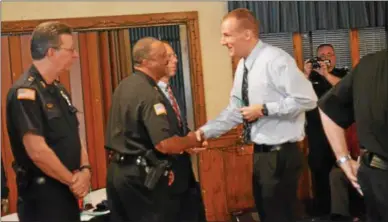  ?? PHOTOS BY JOHN BREWER — ONEIDA DAILY DISPATCH ?? Formerly of the Cazenovia Police Department, Daniel Slator shakes Madison County Sheriff Allen Riley’s hand after accepting his award during the annual Stop DWI awards on Wednesday, May 17.