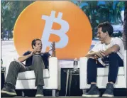  ?? ALFONSO DURAN — THE NEW YORK TIMES ARCHIVES ?? Tyler, left, and Cameron Winklevoss speak at the Bitcoin Festival in Miami, last year. Their company, Gemini, laid off 10% of its staff as the cryptocurr­ency market crashed.