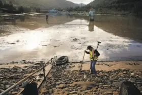  ?? Michael Macor / The Chronicle 2018 ?? Surveyor Tanner Neal tests the integrity of the Moccasin Dam in March 2018.