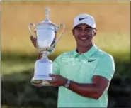  ?? CHRIS CARLSON — THE ASSOCIATED PRESS ?? Brooks Koepka poses with the winning trophy after the U.S. Open golf tournament Sunday at Erin Hills in Erin, Wis.