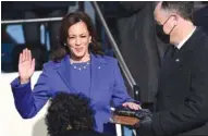  ?? SAUL LOEB/POOL VIA THE NEW YORK TIMES ?? Vice President Kamala Harris is sworn in at the U.S. Capitol on Wednesday as her husband, Doug Emhoff, holds Bibles that once belonged to Regina Shelton, a close family friend, and the late Supreme Court Justice Thurgood Marshall.