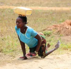  ??  ?? Woman paralysed with polio crawls to a water point. — Photo courtesy of