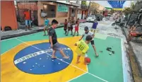  ?? ?? Children play soccer at the Rua 3 avenue in the Brazilian city of Manaus on Nov 12. The avenue has been decorated in support of Brazil’s World Cup campaign in Qatar.*AFP