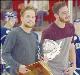  ?? CoDy MCeaCherN/truro Daily NewS ?? Nate Leger, left, and Justin Doiron, members of the Truro Bearcats 2016-17 MHL championsh­ip team, brought the Cup on to the ice prior to the team’s home opener on Saturday.