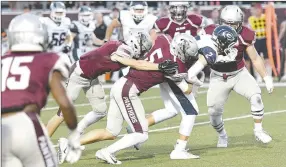  ?? Bud Sullins/Special to the Herald-Leader ?? A host of Siloam Springs defenders wrap up Greenwood’s Luke Leonard during last Friday’s homecoming game at Panther Stadium. Siloam Springs travels to Lake Hamilton this Friday for a 6A-West Conference game.