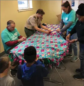  ?? ?? Volunteers work on a blanket as they donate their time during the MLK Day of Service event last year at St. John’s Lutheran Church in Blue Bell.