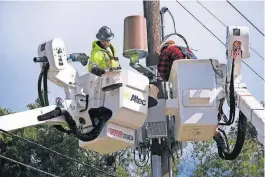  ?? [DOUG HOKE/ THE OKLAHOMAN] ?? Crews from Telamon work to restore utilities last week in Oklahoma City. OG&E said power should be restored to nearly every customer by Friday evening.