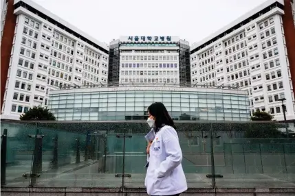 ?? AFP FILE PHOTO ?? EMERGENCY SITUATION
A medical worker walks past the Seoul National University Hospital in South Korea’s capital Seoul on Feb. 21, 2024.