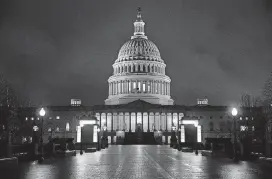  ?? [AP PHOTO] ?? The Capitol is seen before dawn Wednesday after a night of negotiatin­g on the government spending bill. Talks over a $1.3 trillion omnibus bill are almost complete.