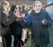  ?? CATHERINE AVALONE — NEW HAVEN REGISTER ?? Quinnipiac guard Carly Fabbri walks through giving high fives to fans as the women’s basketball team attends a Sweet 16 Send-Off Rally at the TD Bank Sports Center.